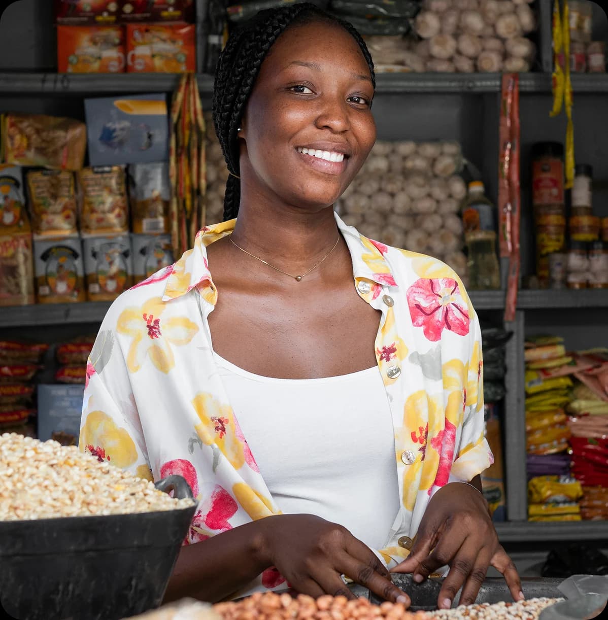 Our story - Woman smiling in a Nigerian grocery store
